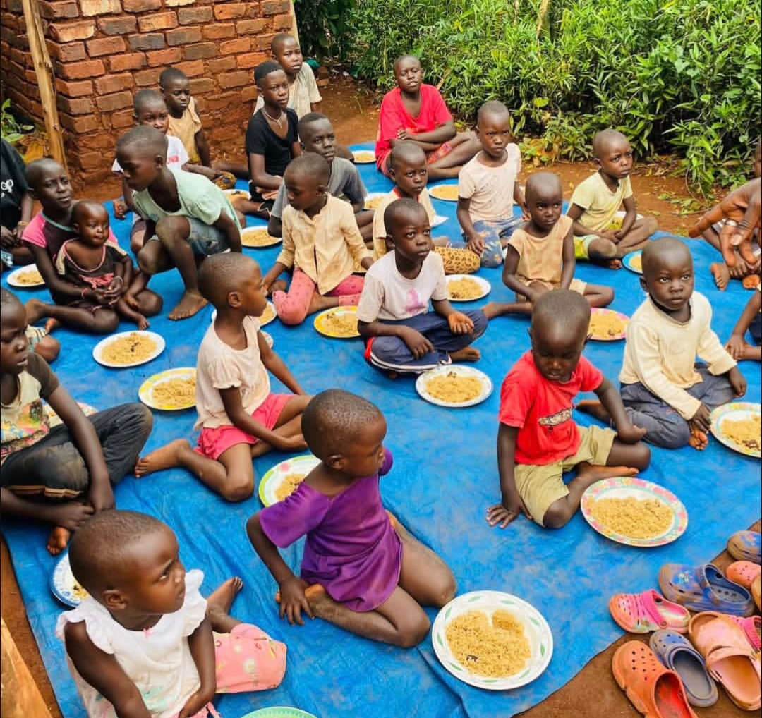Children sharing a meal together at Kwaja Uganda