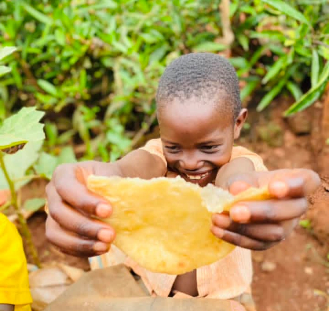 Boy sharing chapati with joy