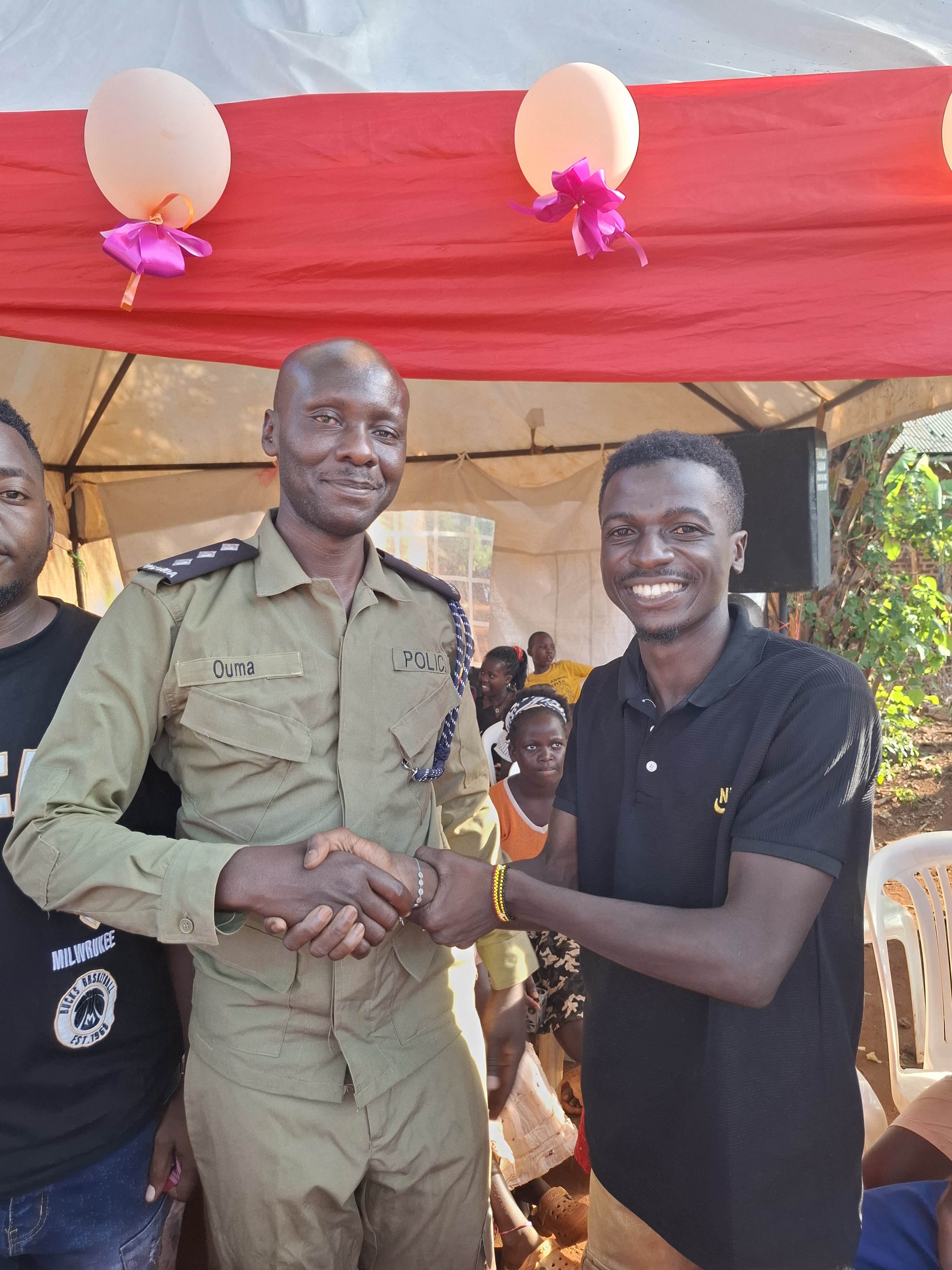Tenywa Fatiik with a community partner at a Kwaja Uganda event